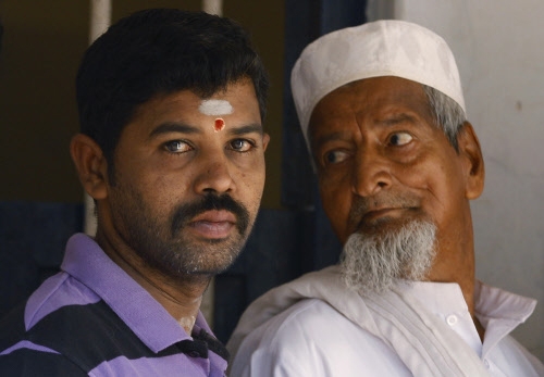muslim stares at a Hindu man at polling station in deccan herald